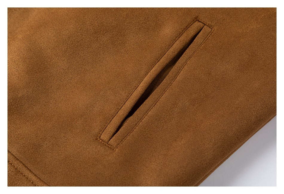 Close-up of a narrow slanted pocket on a camel-brown garment.