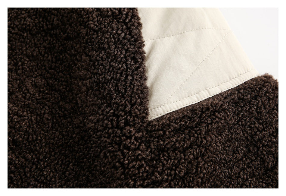 Close-up of dark brown curly fleece beside a cream stitched panel.
