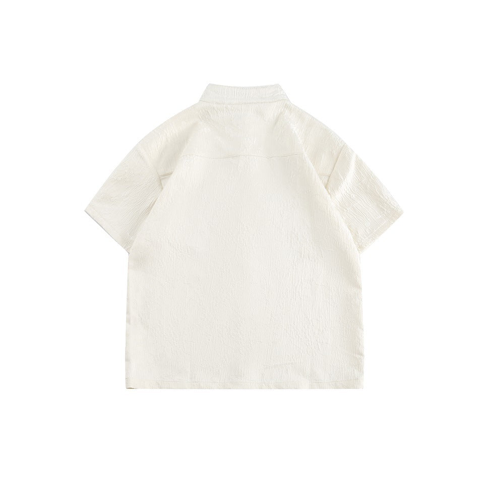 Back view of an ivory short-sleeve shirt with a stand collar and subtle textured fabric.