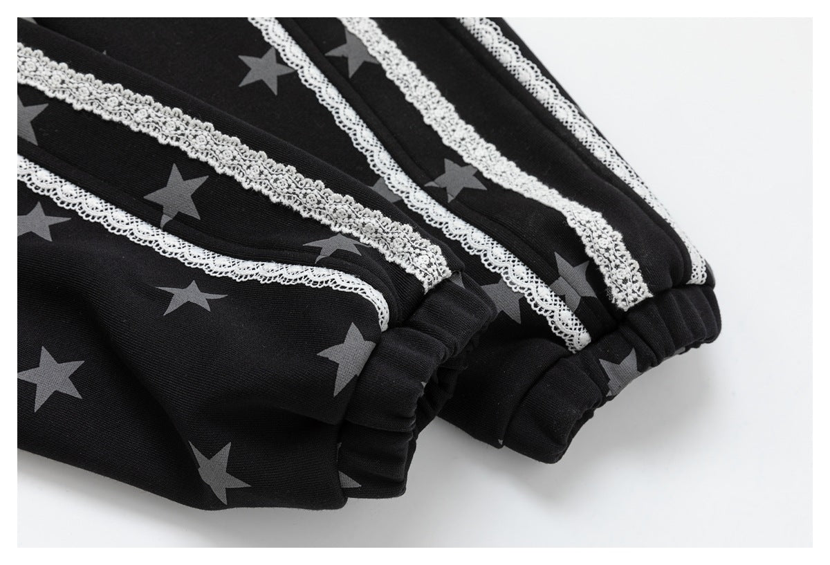 Close-up of black star-print sleeves with white lace trim and gathered elastic cuffs.