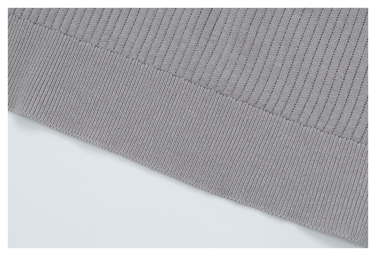 Close-up of the light gray top's ribbed knit and wide ribbed hem.
