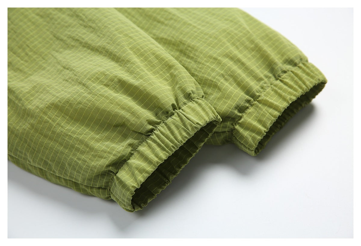 Close-up of the jacket's olive-green, yellow-grid-patterned elastic cuffs.