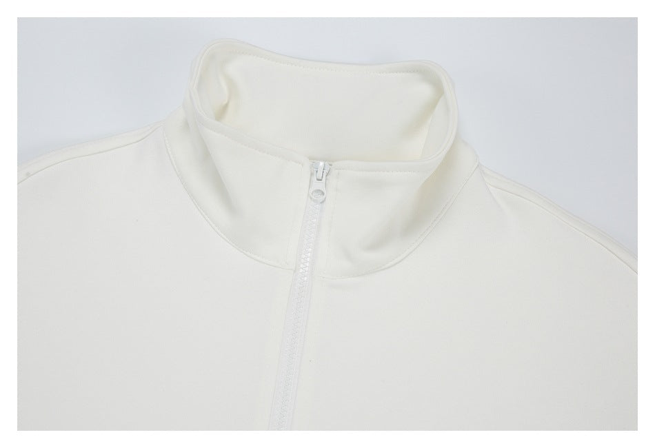 Close-up of an off-white jacket's stand collar and front zipper.