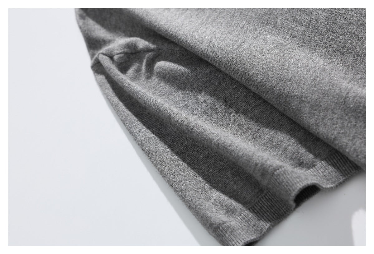 Close-up of a folded section of the gray sweater with a narrow ribbed edge.