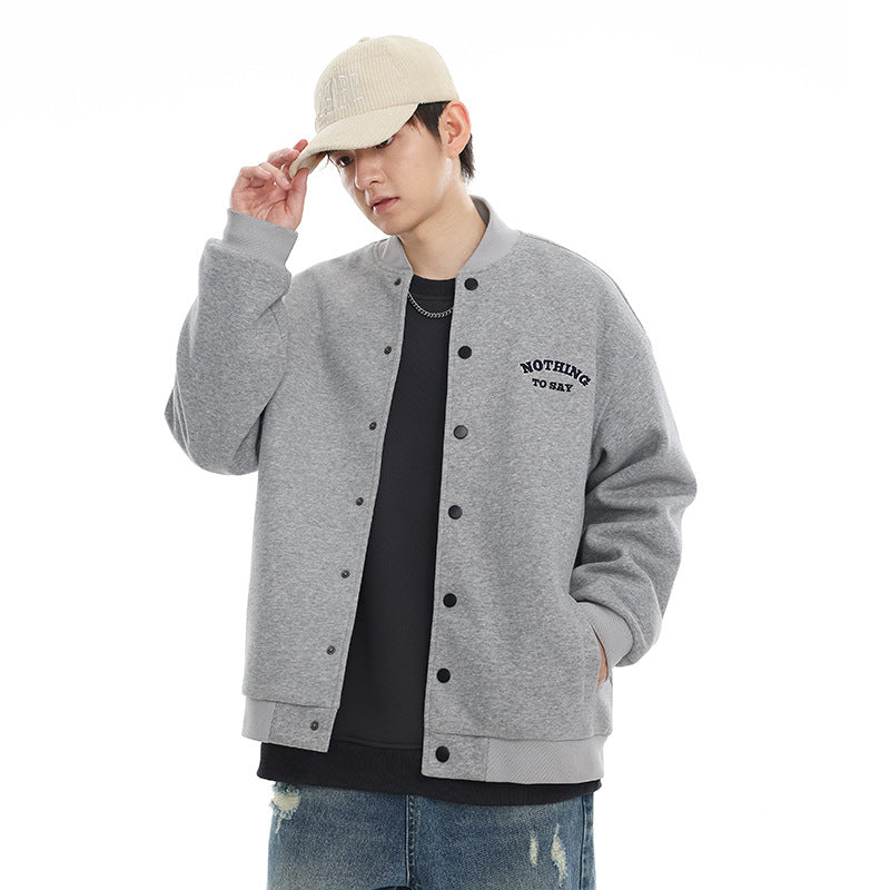 Model wearing a light gray snap-front varsity jacket with ribbed trim and small chest lettering.