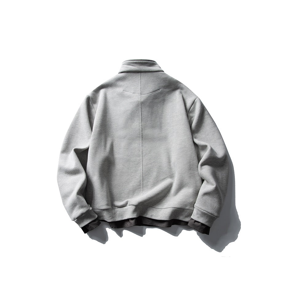 Back view of a light gray sweatshirt with a high collar, long sleeves, and ribbed hem and cuffs.