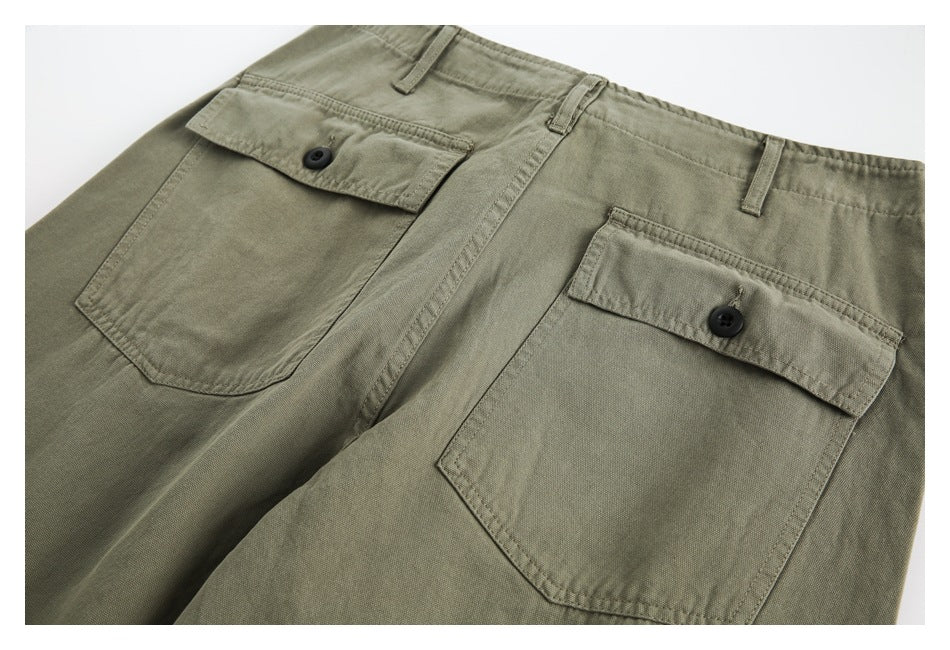 Olive-khaki shorts shown from the back, with two large button-flap pockets and belt loops.