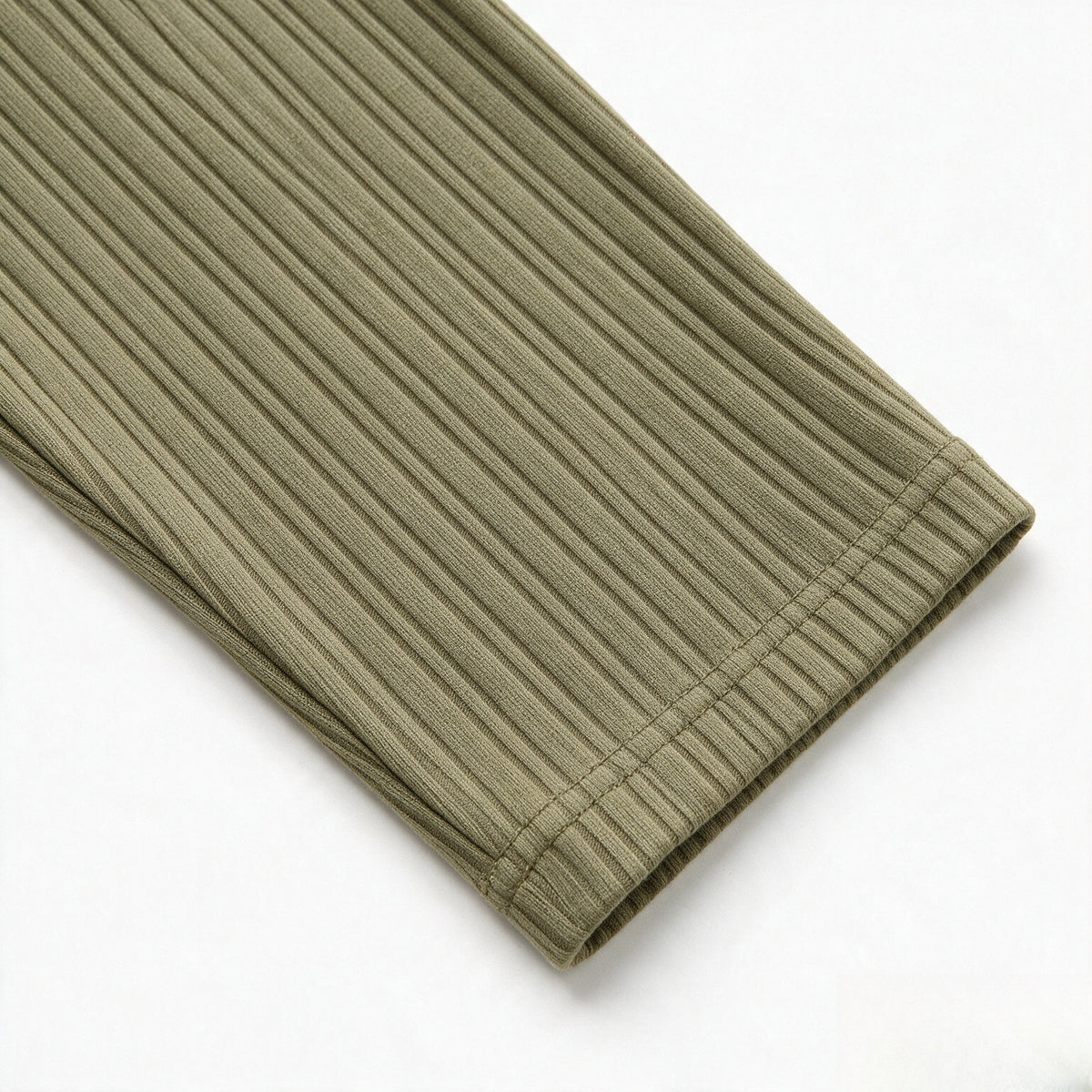 Close-up of the olive ribbed shirt's long sleeve and stitched cuff.
