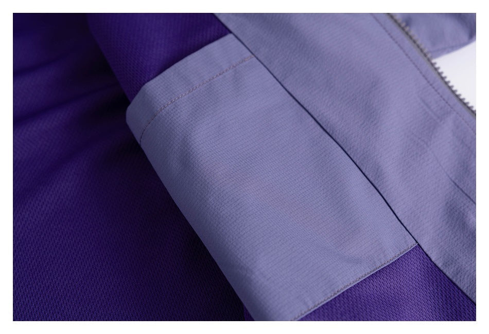 Close-up showing purple mesh lining, a lavender fabric panel, stitching, and zipper edge.