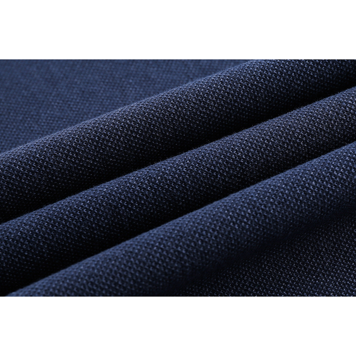 Close-up of dark navy knit fabric arranged in soft folds.