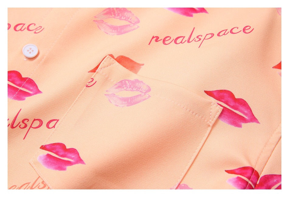Close-up of a rectangular patch pocket on peach fabric printed with pink lips and lettering.