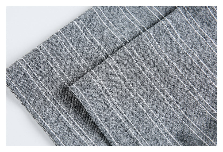 Close-up of gray heathered striped fabric showing a folded edge and seam.