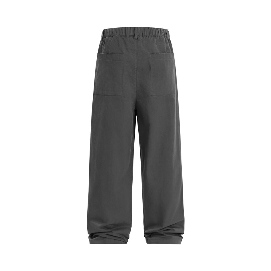 Back view of charcoal wide-leg trousers with an elastic waistband and two patch pockets.