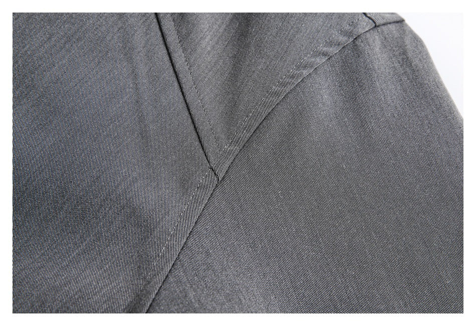 Close-up of a gray jacket seam and stitched panel construction.