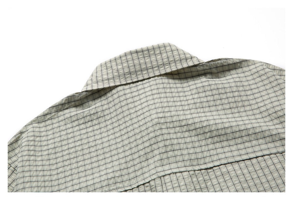 Close-up of the checked shirt's back collar and upper back on a white background.