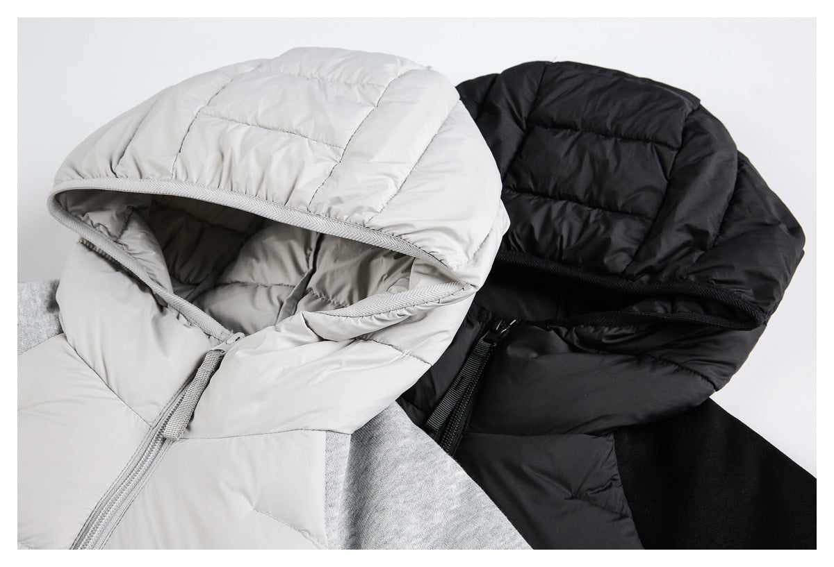Close-up of light gray and black jacket hoods, quilting, zipper edges, and contrasting sleeve fabric.