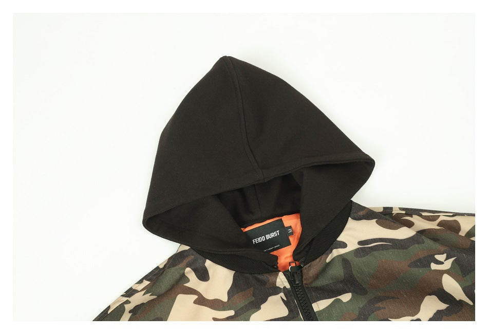 Close-up of the jacket's black hood, camouflage shoulder, zipper, orange lining, and neck label.