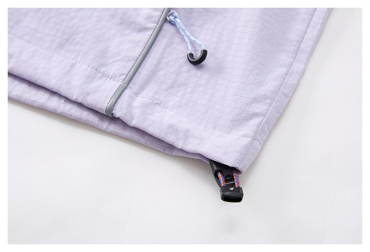 Close-up of the pale lavender jacket hem, gray piping, drawcord hook, and black toggle.