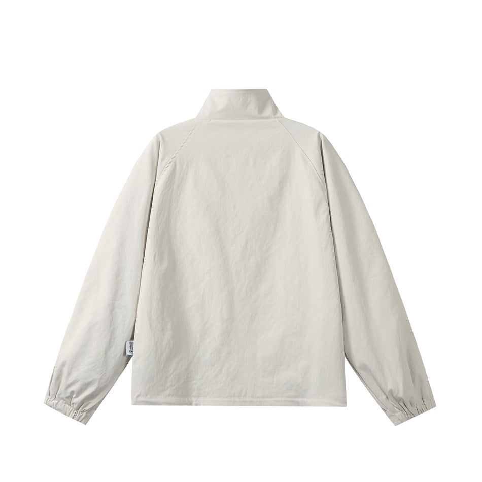 Beige jacket back flat lay showing stand collar, raglan sleeves, gathered elastic cuffs and small sleeve label