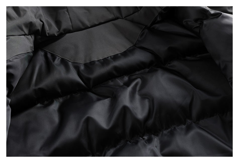 Close-up of the charcoal jacket's dark quilted interior lining.
