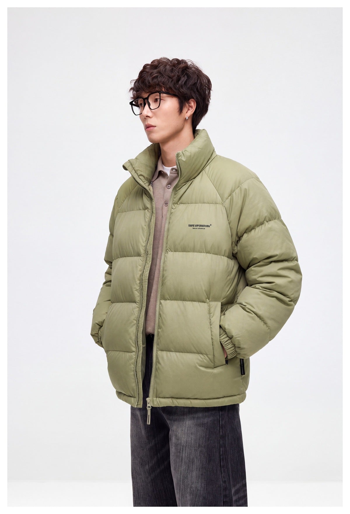 Angled view of a model wearing a light olive quilted puffer jacket with a raised collar and zip front.
