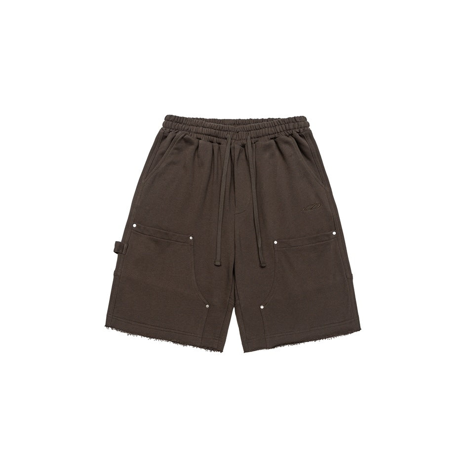 Brown drawstring knee-length shorts with front patch pockets, metal rivets and raw hems, front view