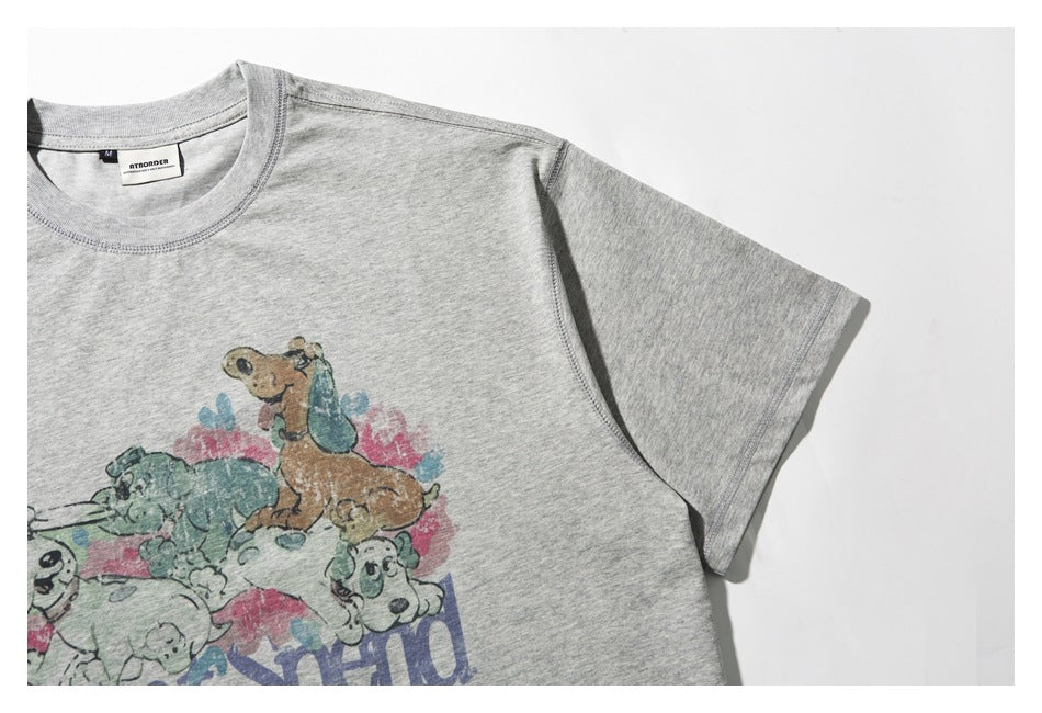 Angled close-up of a light gray T-shirt showing its sleeve and part of a faded cartoon dog print.