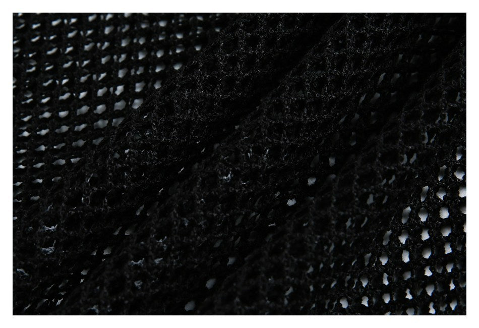 Macro view of black open-knit mesh and its textured yarn construction.