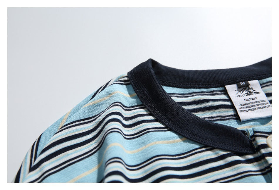 Close-up of the shirt's dark ribbed collar, striped shoulder, and sewn-in neck label.