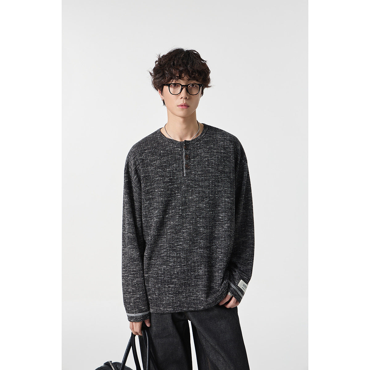 Model wearing a charcoal heathered long-sleeve henley with a three-button placket.