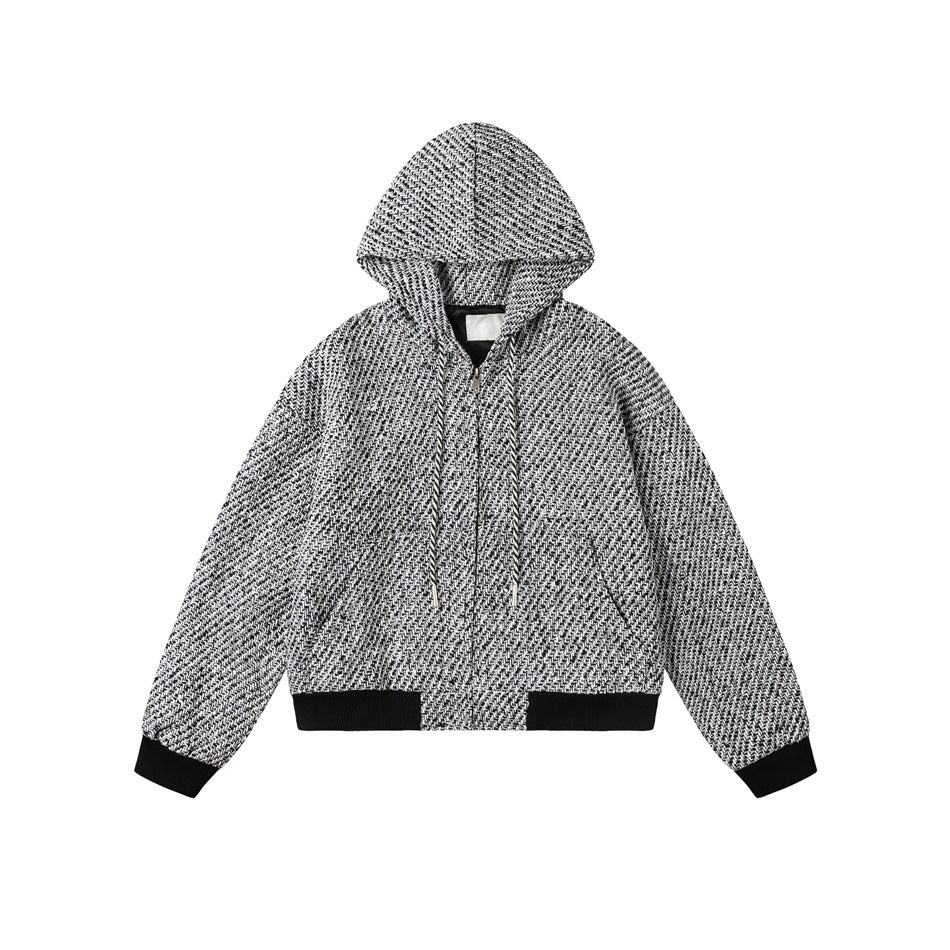 Flat-lay of a black and white tweed-textured hooded zip jacket with drawstrings and black ribbed cuffs and hem