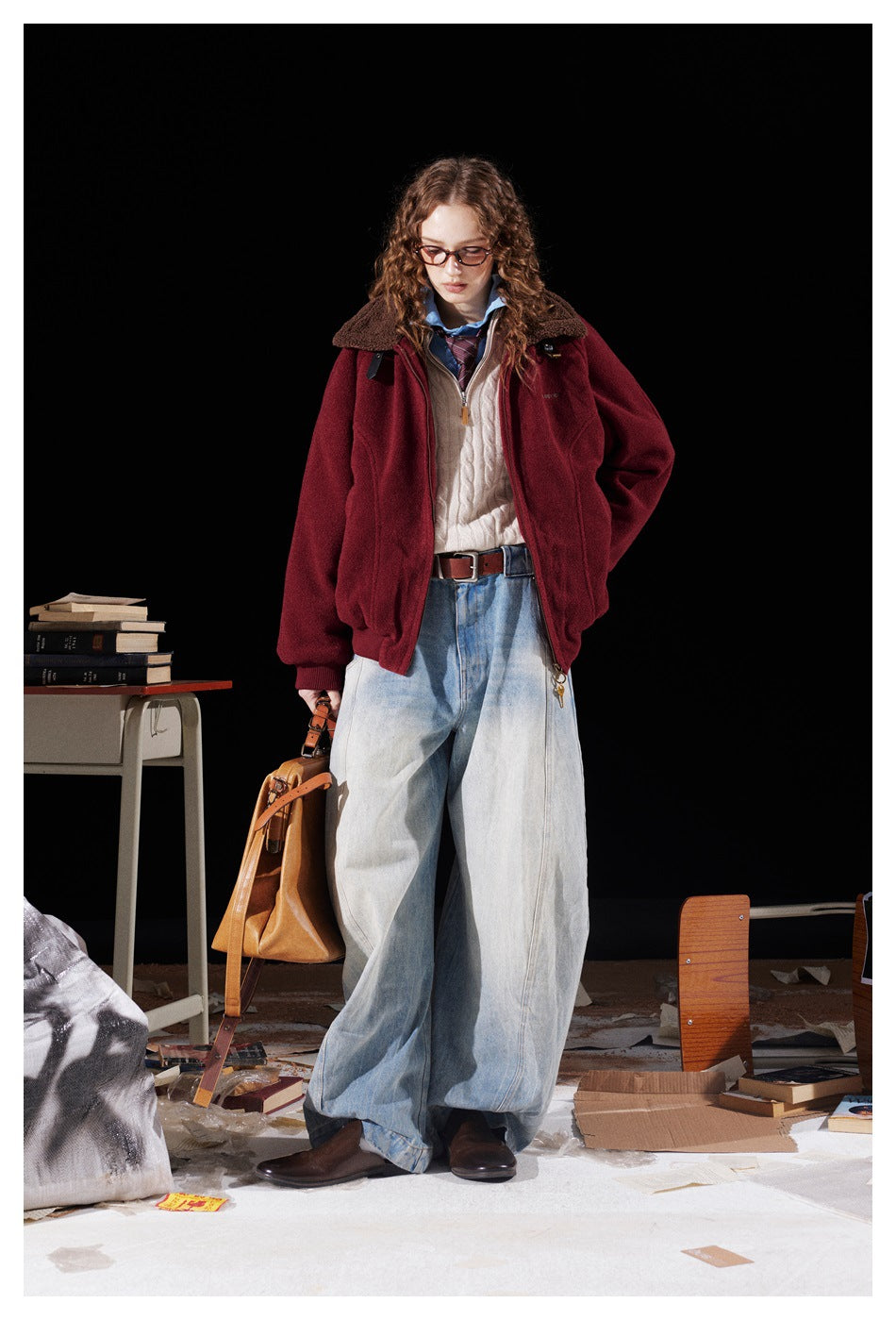 Full-length view of a model wearing a burgundy fleece-collar jacket with loose, light-wash jeans.
