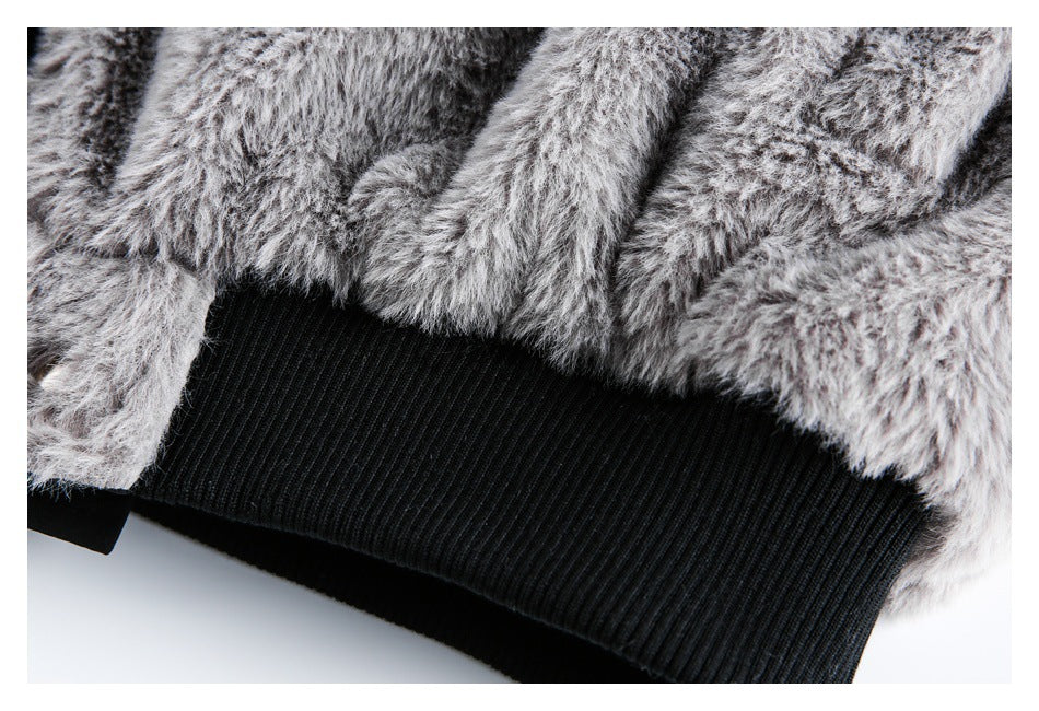 Close-up of the shaggy gray garment hem above a wide black ribbed waistband.