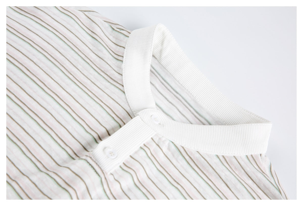 Close-up of the shirt's white ribbed band collar and button placket against fine muted stripes.