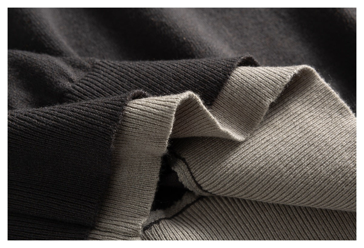 Close-up of a charcoal ribbed cuff folded back to show the taupe knit layer beneath.