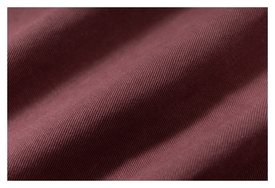 Macro view of the dusty rose garment's fine diagonal surface texture.
