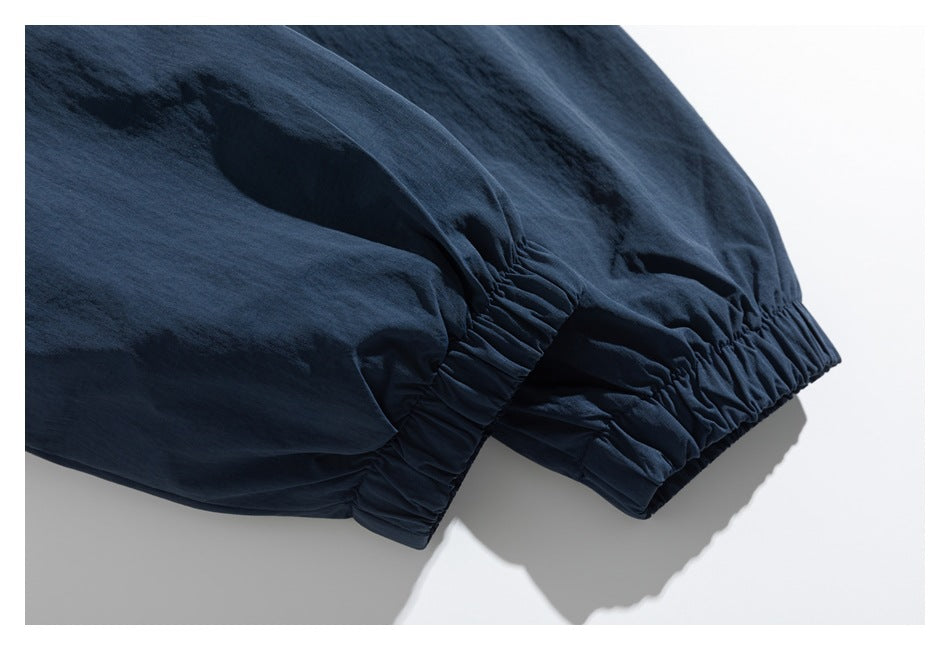 Close-up of a dark navy garment with gathered elastic cuffs.
