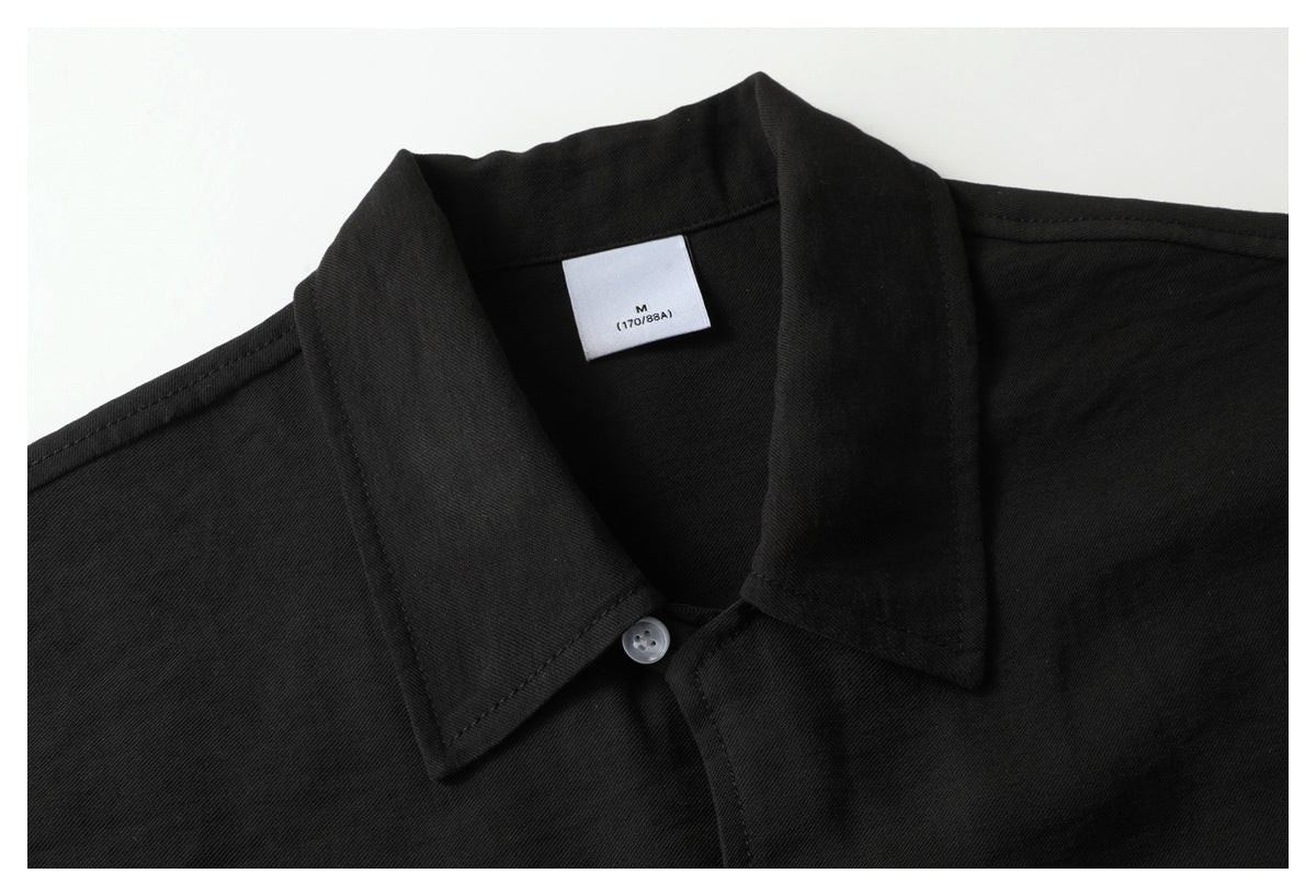 Close-up of a black collared shirt with a white size label reading M (170/88A).