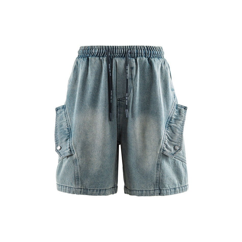Front view of faded blue denim-look cargo shorts with drawstring waist and snap-button side cargo pockets