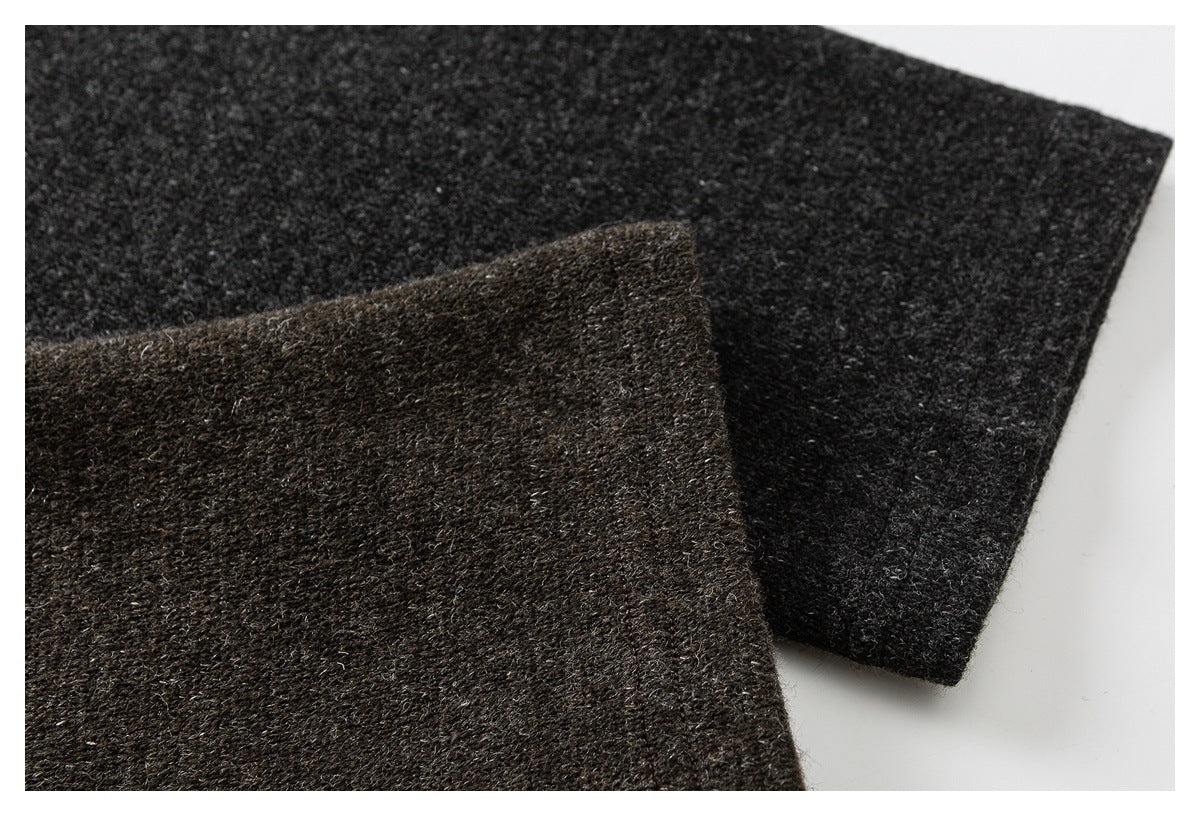 Close-up of overlapping brown and charcoal textured fabric panels.