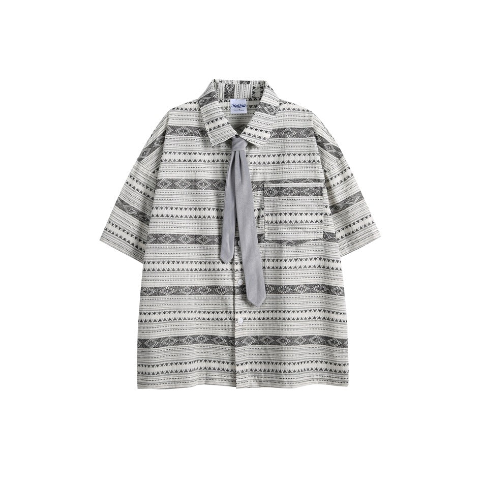 Gray and cream geometric striped short-sleeve button shirt with chest pocket and gray tie, flat lay