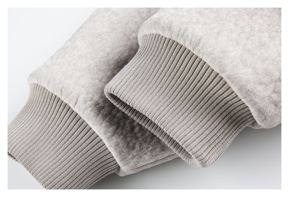 Close-up of the jacket sleeve ends with wide taupe ribbed cuffs.