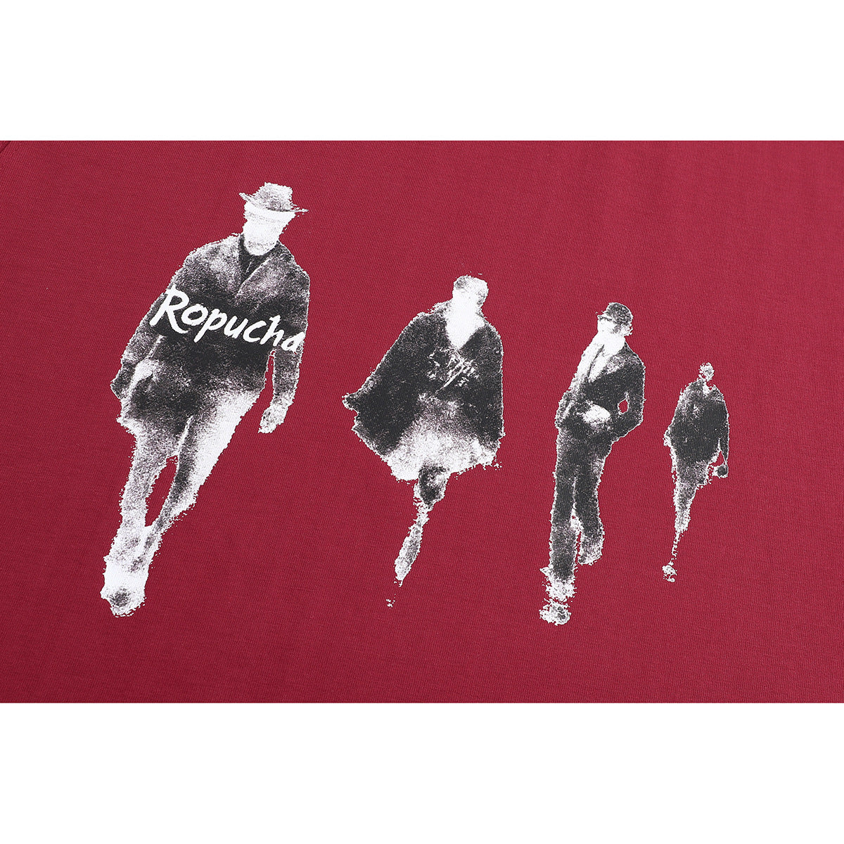 Close-up of a burgundy shirt graphic with four monochrome walking figures and the word “Ropucha.”