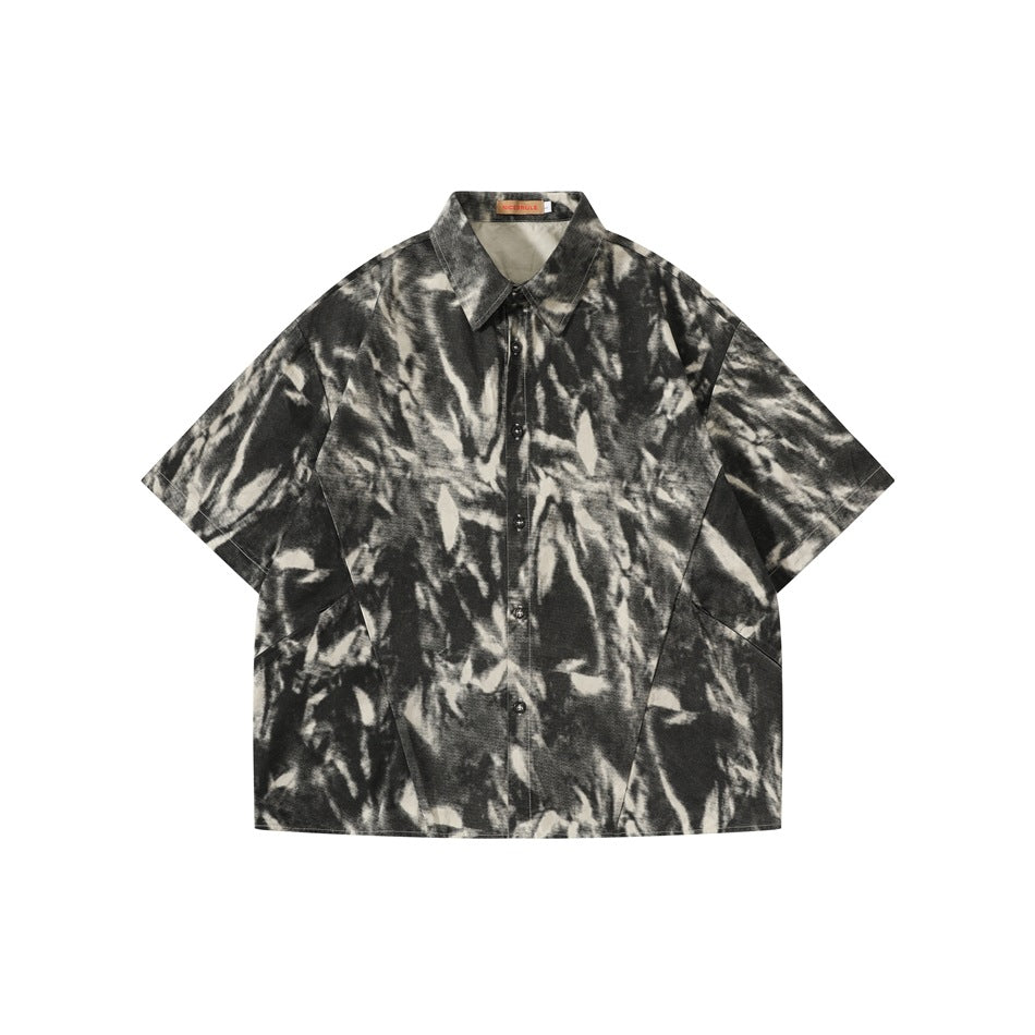 Ink gray short-sleeve button-up shirt with black, gray and cream tie-dye style print, flat front view