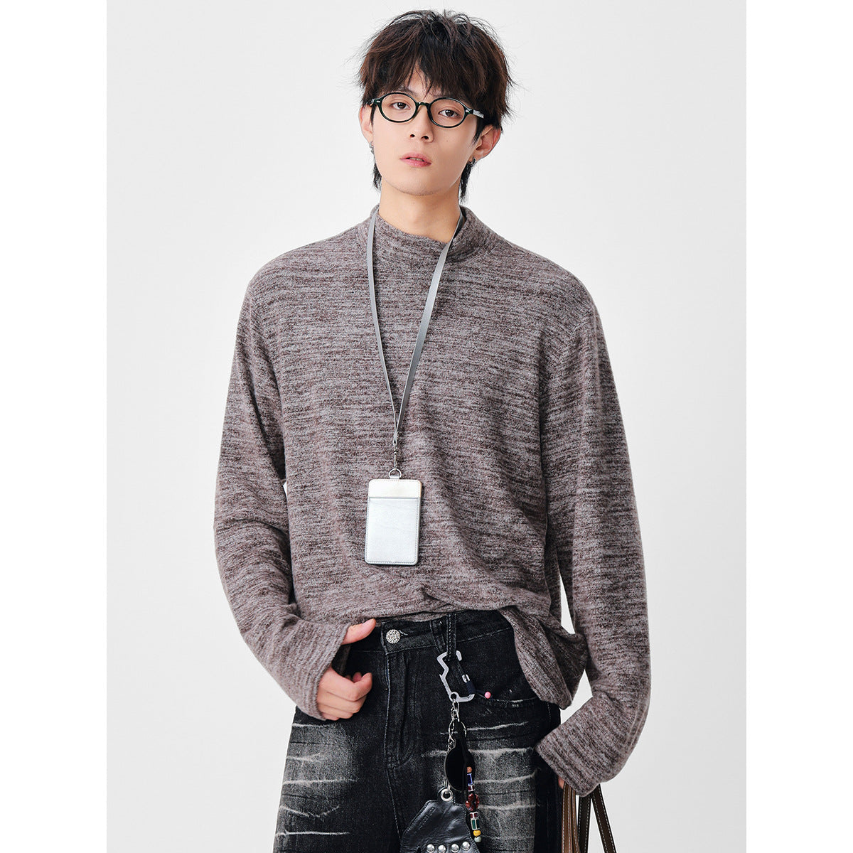 Model wearing a taupe-gray marled long-sleeve top, slightly tucked at the waist.