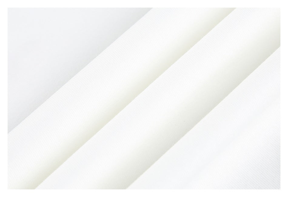 Close-up of white fabric with a fine, subtle texture and soft diagonal folds.