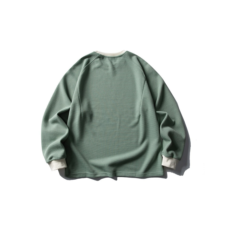 Back view of a sage-green textured crewneck sweatshirt with ivory collar and cuffs.