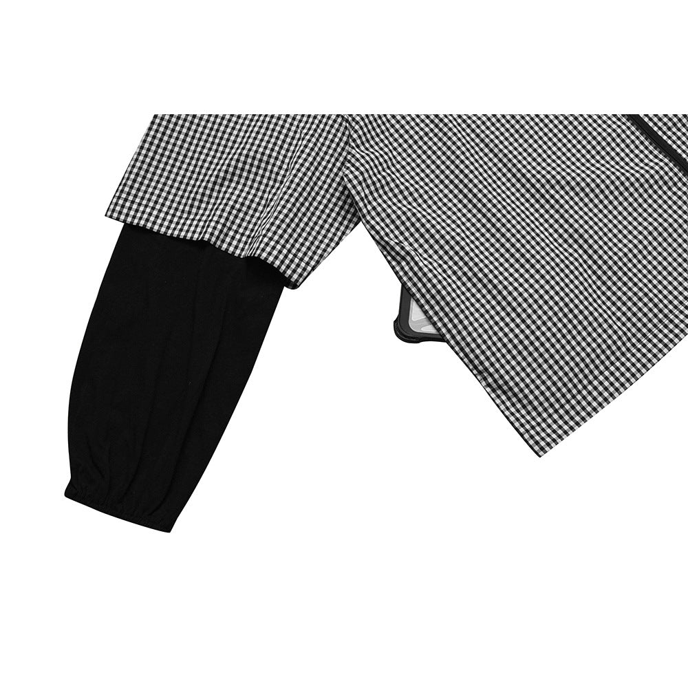 Close-up of a gingham jacket sleeve layered over a long black sleeve, with the front panel at right.
