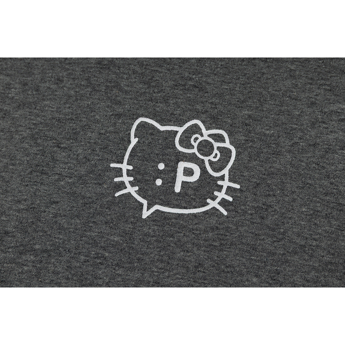 Close-up of a white outlined cat-face graphic with a bow and ":P" on gray T-shirt fabric.