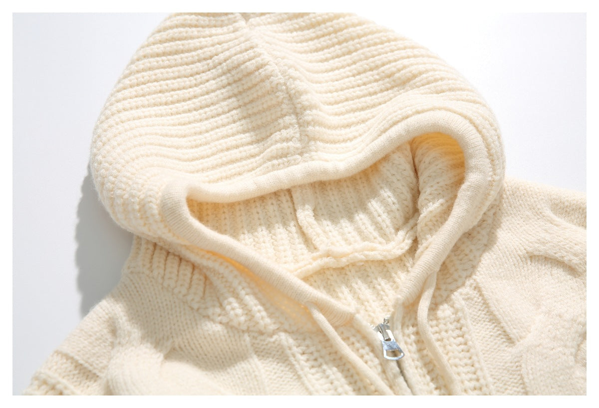 Close-up of the cream sweater's ribbed hood opening and silver zipper pull.